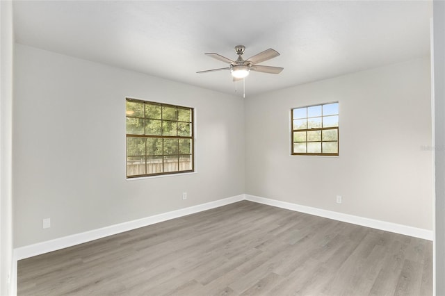 spare room with light wood-type flooring and ceiling fan