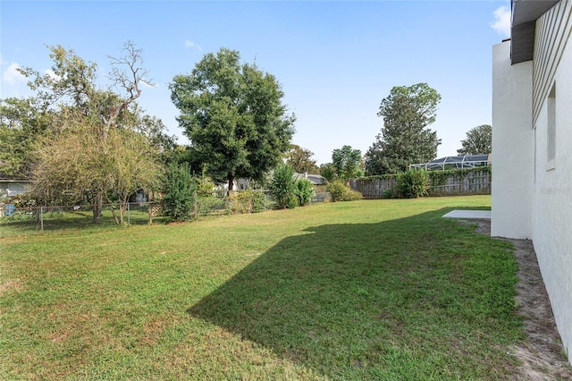 view of yard featuring glass enclosure