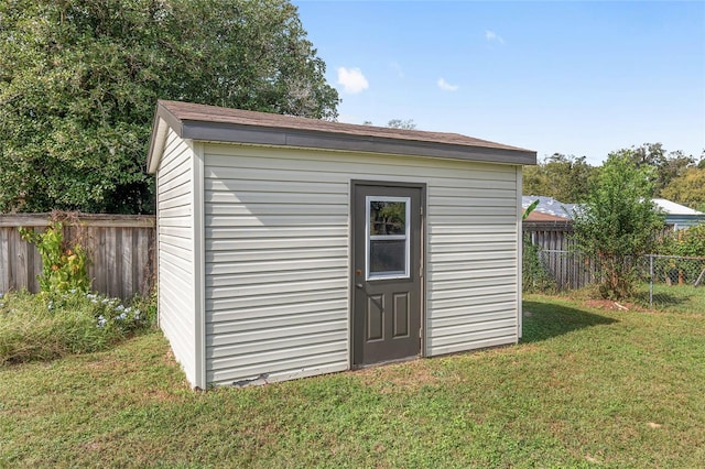 view of outbuilding featuring a lawn