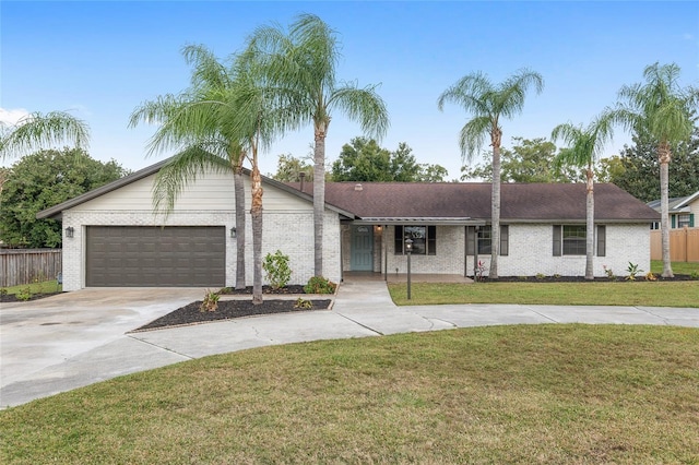 ranch-style home with a garage and a front lawn