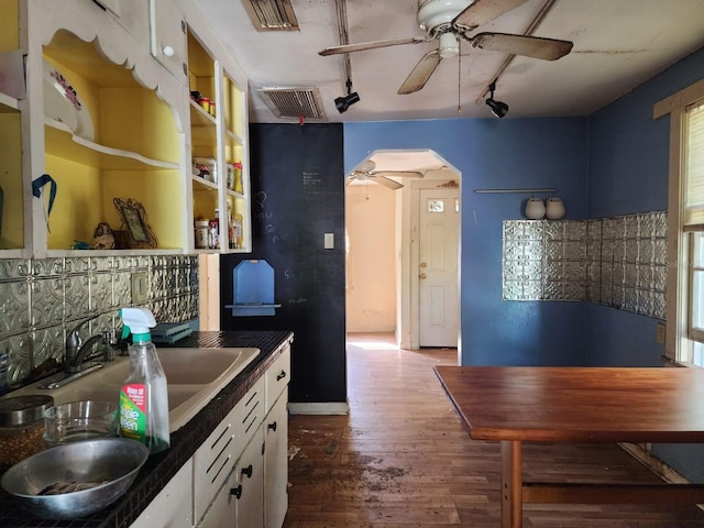 kitchen with white cabinetry, track lighting, sink, hardwood / wood-style floors, and a healthy amount of sunlight