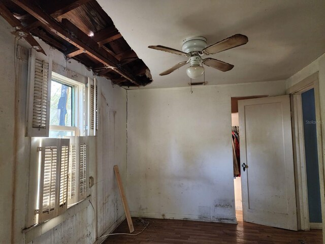 empty room featuring dark hardwood / wood-style flooring and ceiling fan