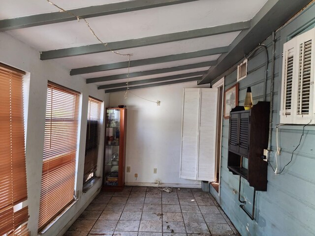 interior space featuring vaulted ceiling with beams