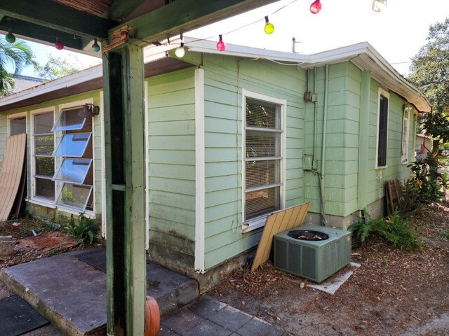 view of side of home with central AC unit