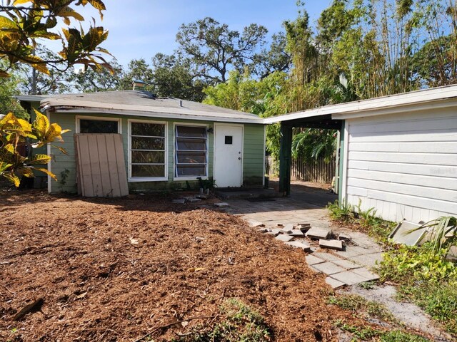 back of property featuring a carport