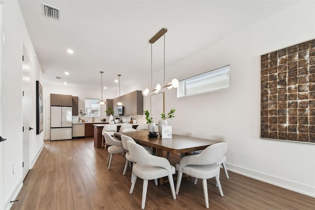 dining room with dark wood-type flooring