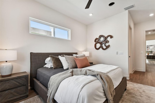 bedroom featuring ceiling fan and dark hardwood / wood-style flooring