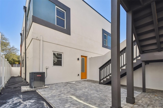 rear view of house with a patio and cooling unit