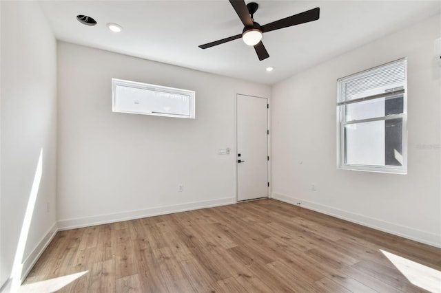 spare room featuring ceiling fan and light hardwood / wood-style flooring