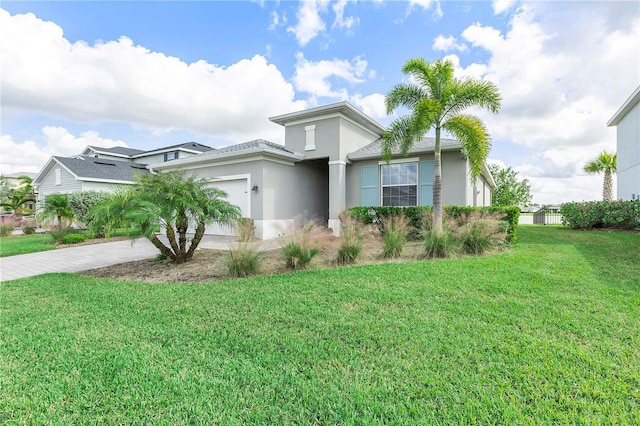 view of front facade with a garage and a front lawn