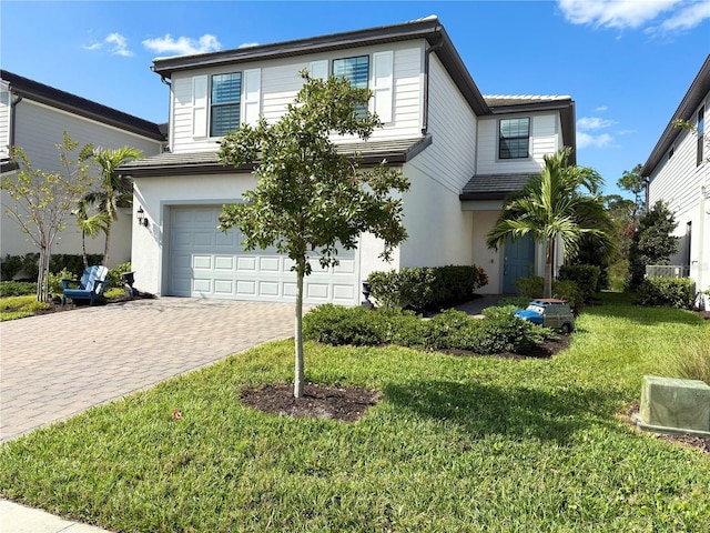 view of front property featuring a garage and a front yard