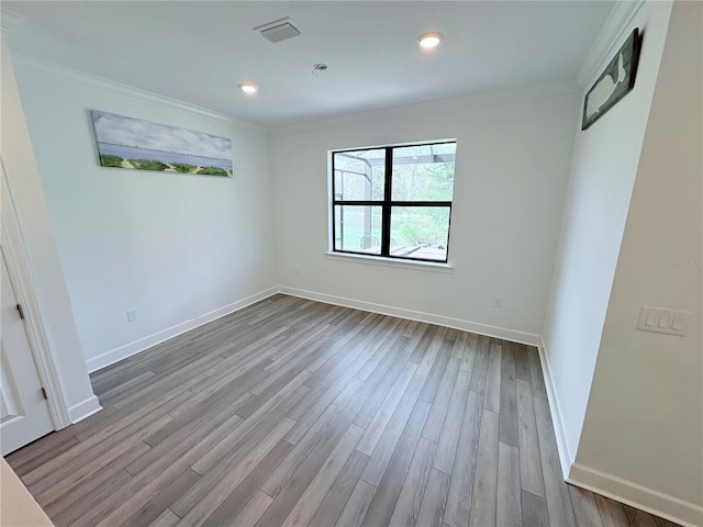 unfurnished room featuring ornamental molding and hardwood / wood-style floors