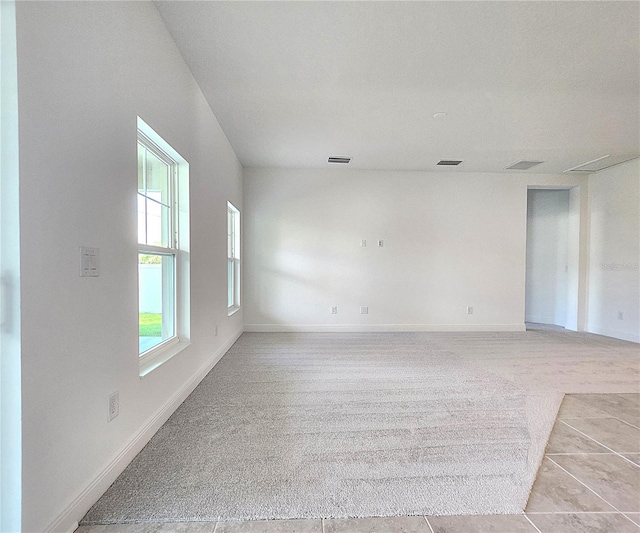 carpeted empty room featuring a healthy amount of sunlight