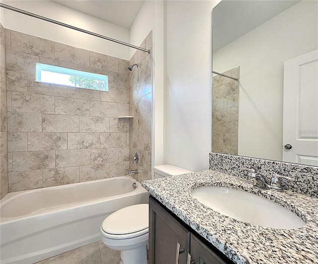 full bathroom featuring toilet, vanity, tiled shower / bath combo, and tile patterned floors