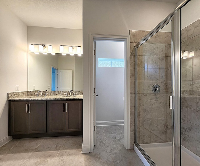 bathroom featuring walk in shower, vanity, and tile patterned floors