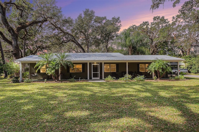 ranch-style home with a yard