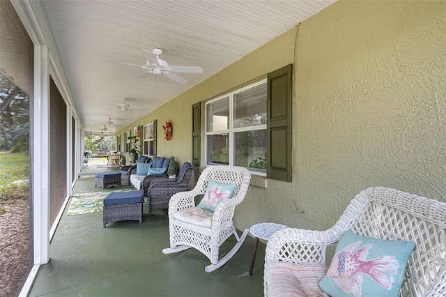 sunroom featuring ceiling fan