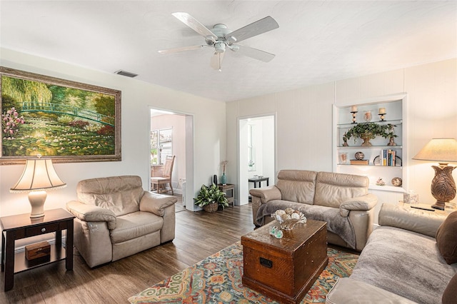 living room with ceiling fan and dark hardwood / wood-style floors