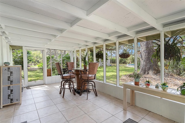 sunroom / solarium featuring beam ceiling