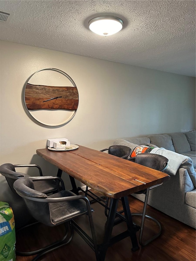 office area with dark hardwood / wood-style flooring and a textured ceiling