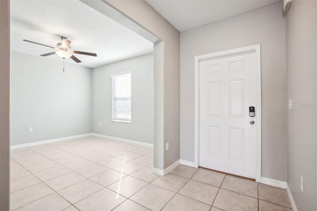 foyer with ceiling fan and light tile patterned floors