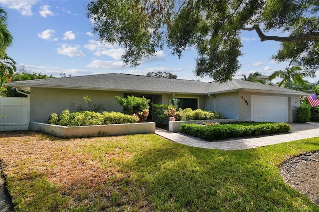 single story home with a garage and a front yard