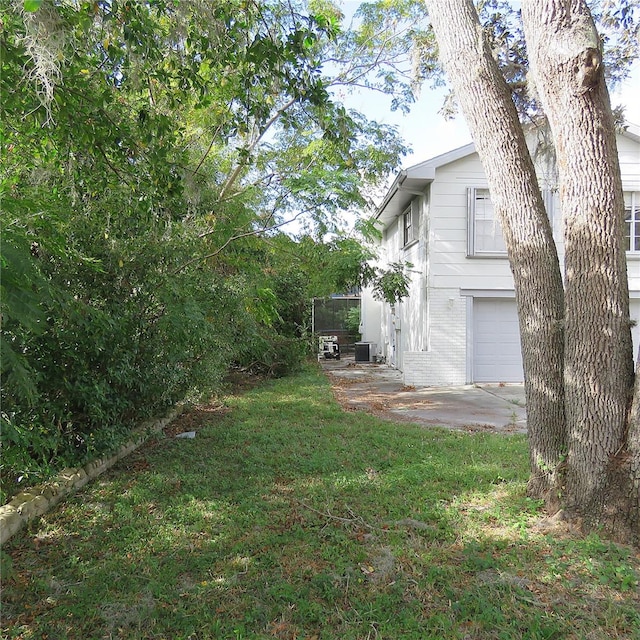 view of yard with a garage and cooling unit