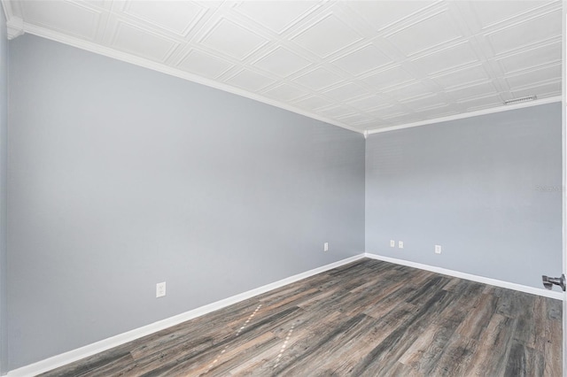 empty room featuring crown molding and dark hardwood / wood-style floors