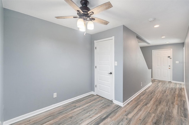 unfurnished room featuring ceiling fan and dark hardwood / wood-style floors