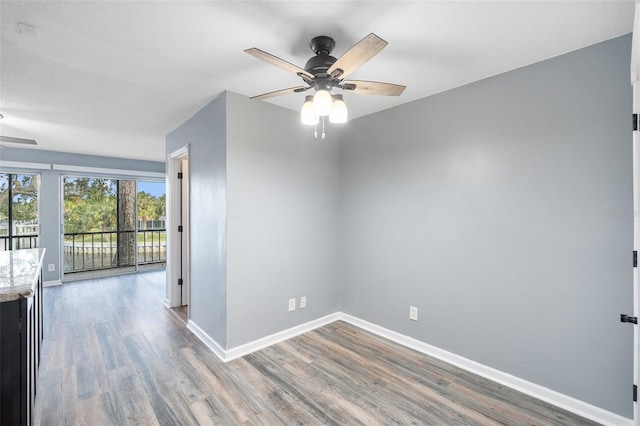 unfurnished room with ceiling fan and hardwood / wood-style floors