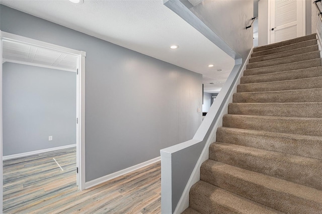 stairs featuring hardwood / wood-style flooring