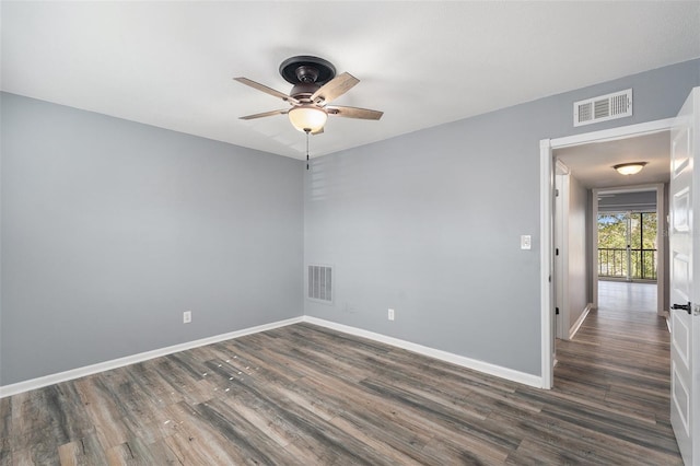 unfurnished room with ceiling fan and dark hardwood / wood-style floors