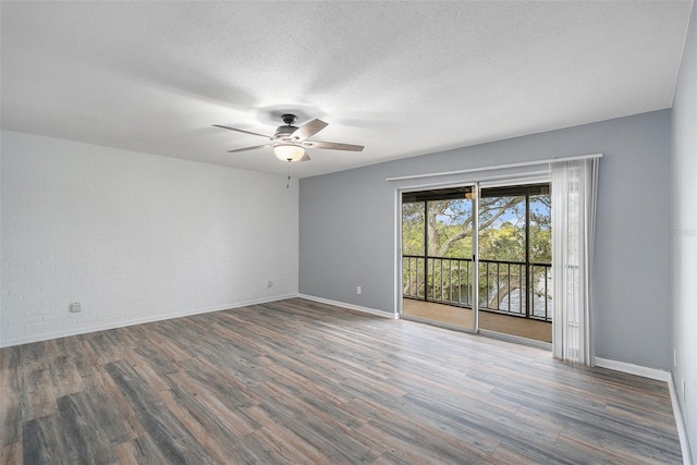 empty room with a textured ceiling, dark hardwood / wood-style flooring, and ceiling fan