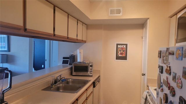 kitchen featuring stainless steel dishwasher, sink, white refrigerator, white cabinets, and range