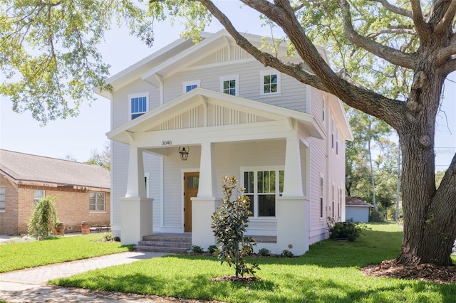 view of front facade with a front yard and a porch