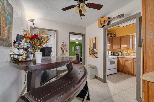 interior space with a textured ceiling and ceiling fan