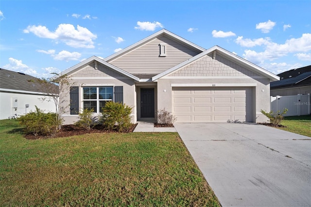 view of front of house featuring a front lawn and a garage