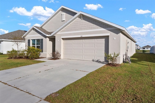 view of front of home featuring a garage and a front lawn