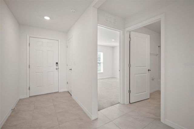 hall featuring light tile patterned floors