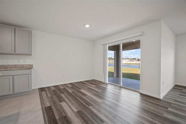 unfurnished dining area with dark wood-type flooring