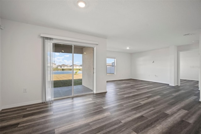 unfurnished living room with dark wood-type flooring