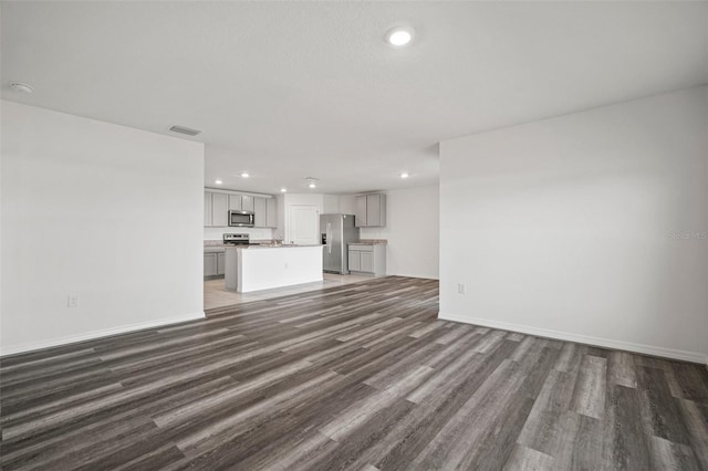 unfurnished living room with dark hardwood / wood-style floors