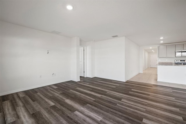 unfurnished living room featuring dark hardwood / wood-style floors