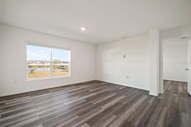 spare room with dark hardwood / wood-style flooring