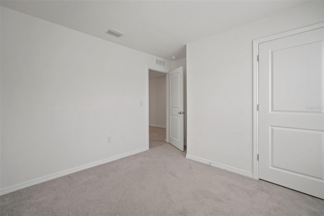 unfurnished room with light colored carpet