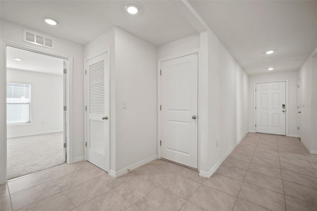 hallway featuring light tile patterned floors