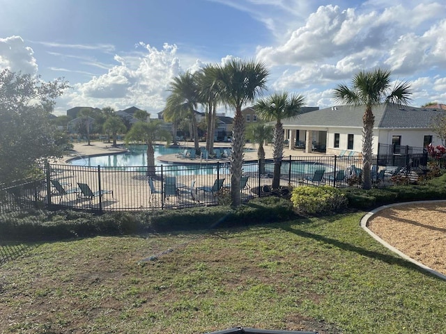 view of swimming pool with a patio area and a yard