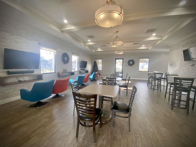 dining space with beam ceiling, crown molding, and hardwood / wood-style flooring