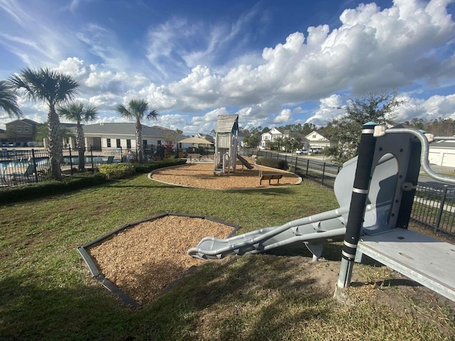 view of playground with a lawn