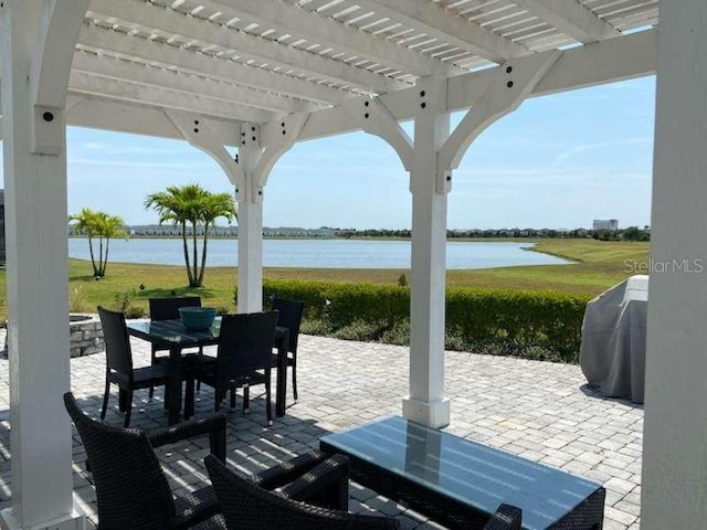 view of patio / terrace featuring a water view, a pergola, and grilling area